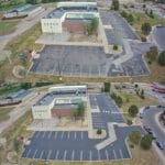 A parking lot in Monument transformed by asphalt repair, crack sealing, sealcoating, and re-striping