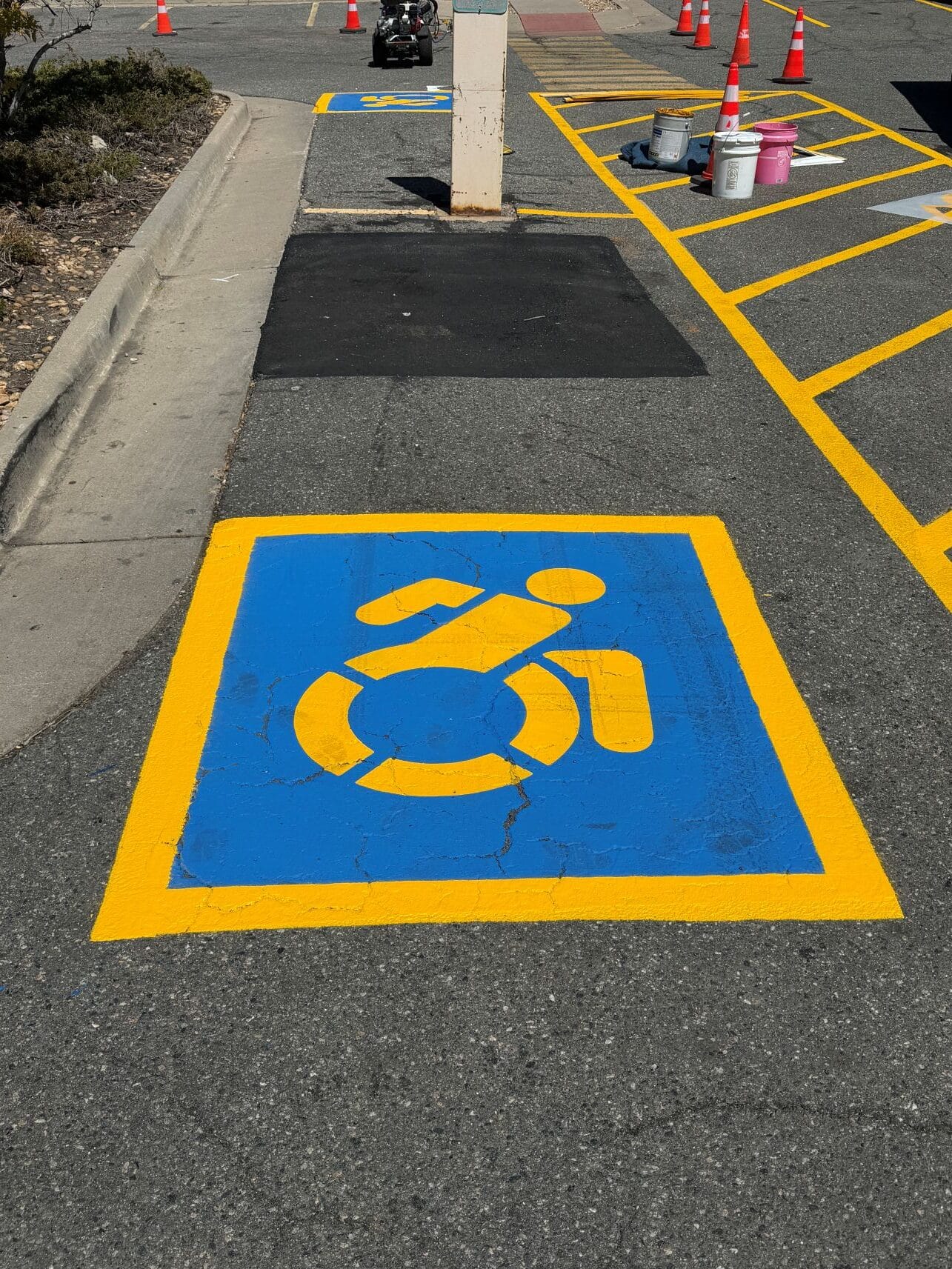 ADA parking stencil with yellow paint